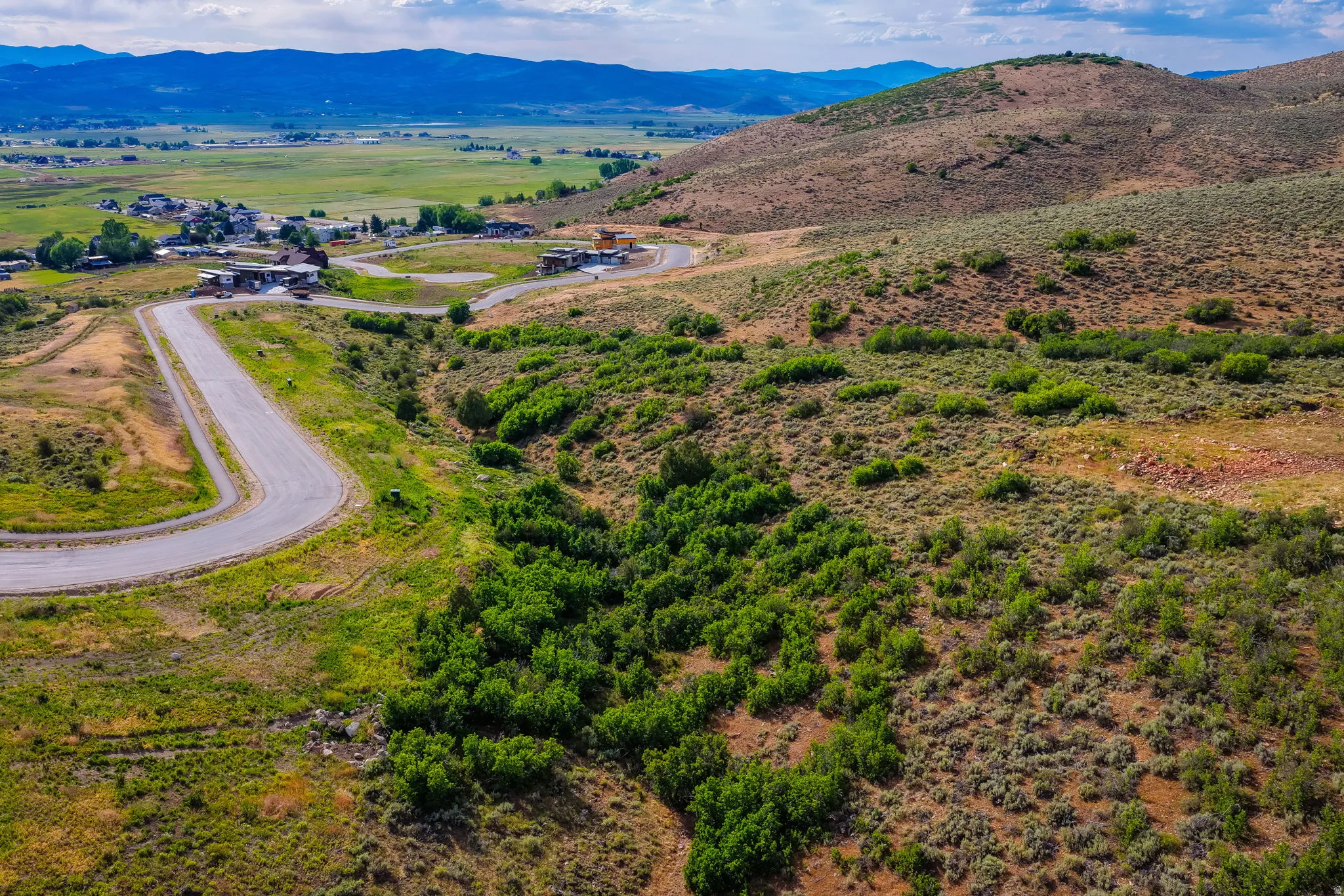 Expansive undeveloped land featuring rolling hills and varied natural vegetation