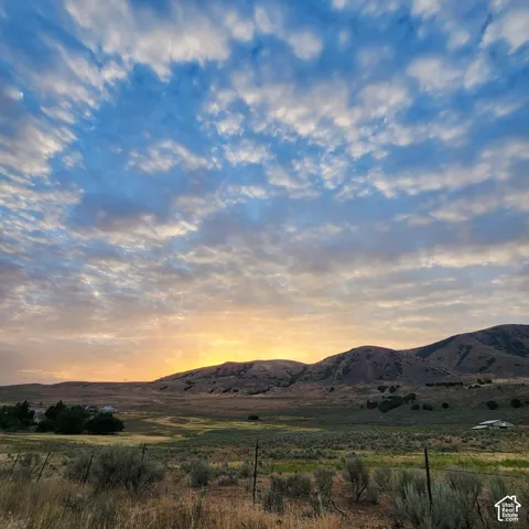 Expansive landscape featuring rolling hills and beautiful sunsets.