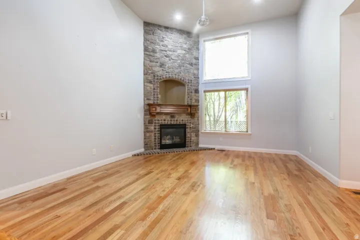 Soaring ceilings complement the stone-clad fireplace with a wood mantle
