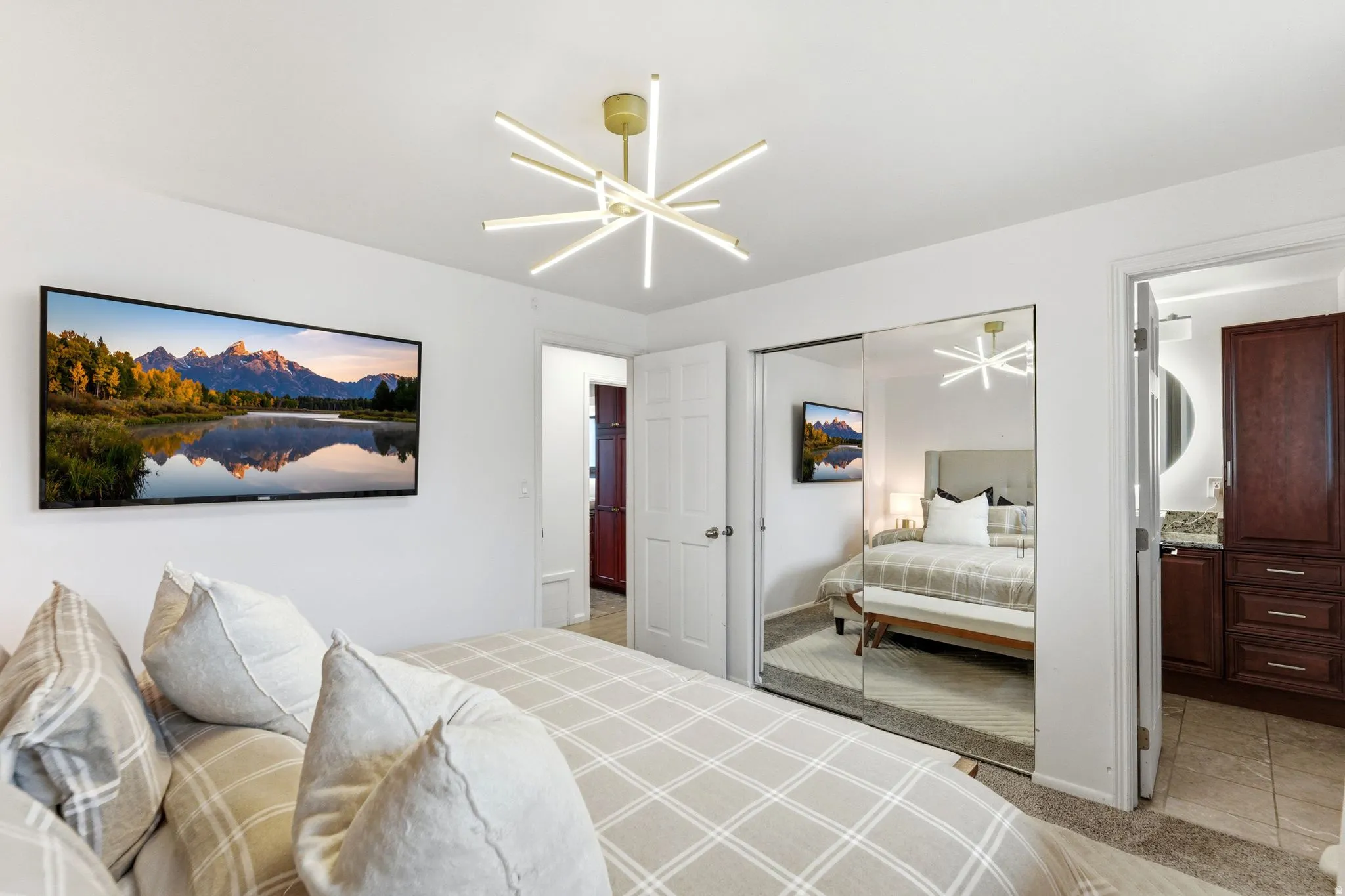 Recessed lighting and a contemporary Sputnik-style chandelier illuminate this space