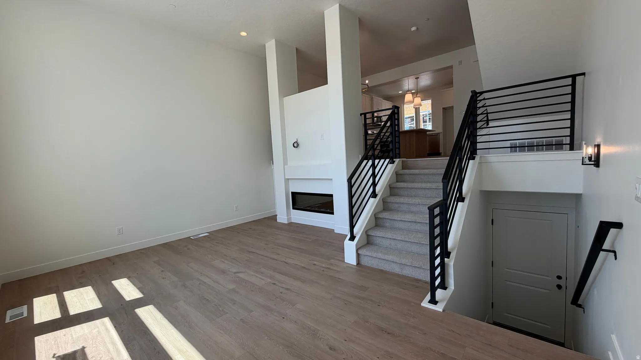 Open-concept living space with wood-finish flooring