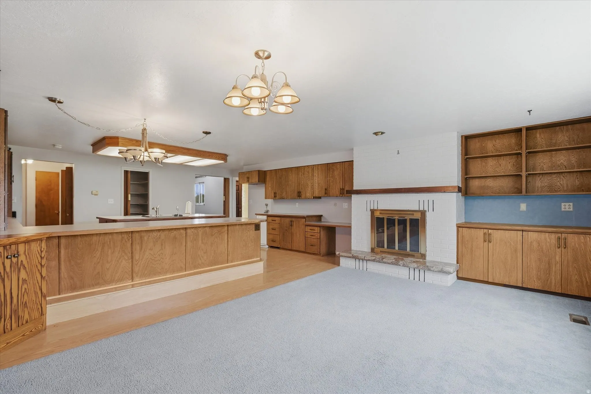 Bright living area featuring a fireplace with a stone hearth and brass insert