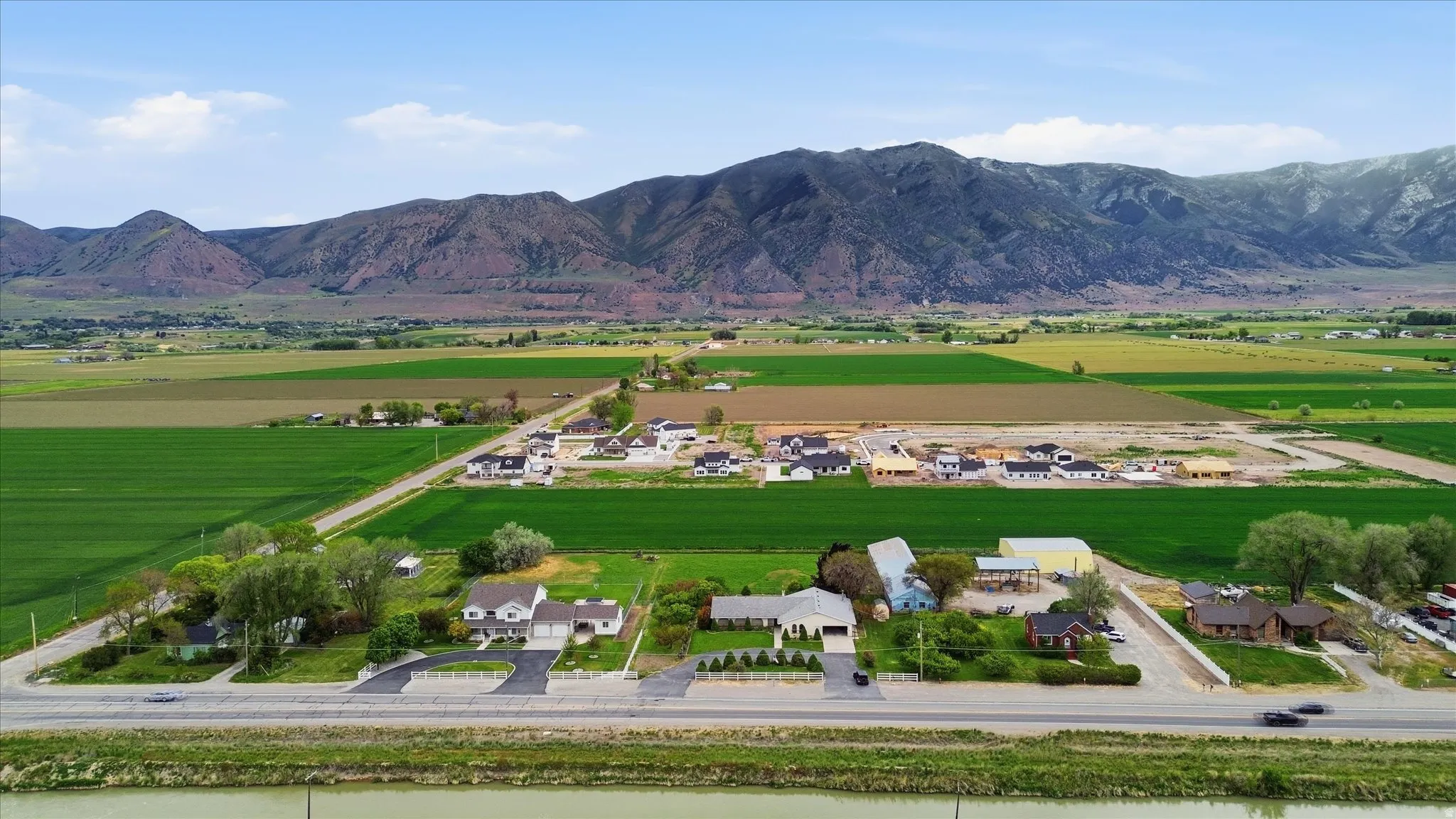 Agricultural landscape with distant mountains featuring snow-capped peaks