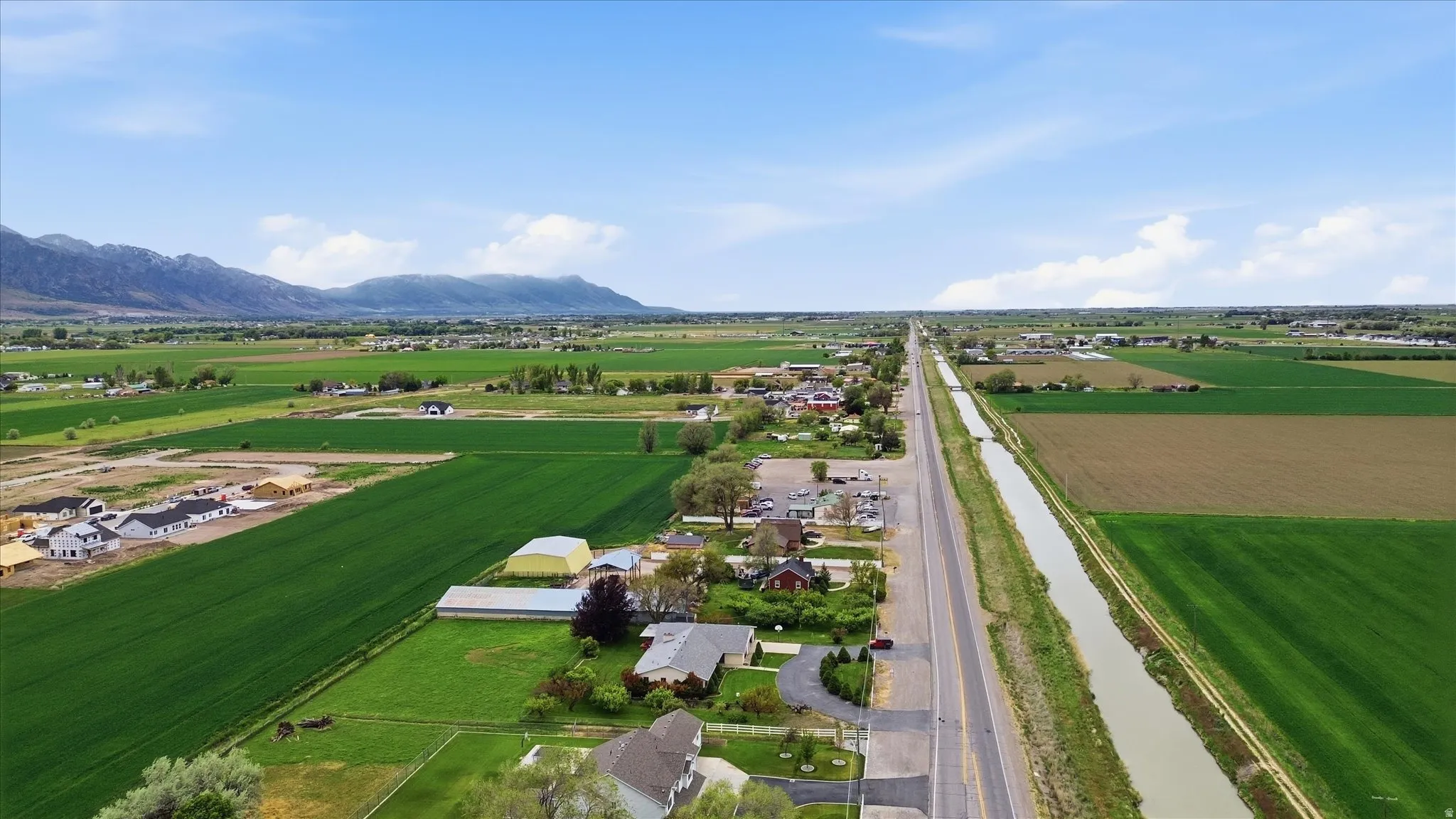 Rural landscape featuring distant mountains under a blue sky