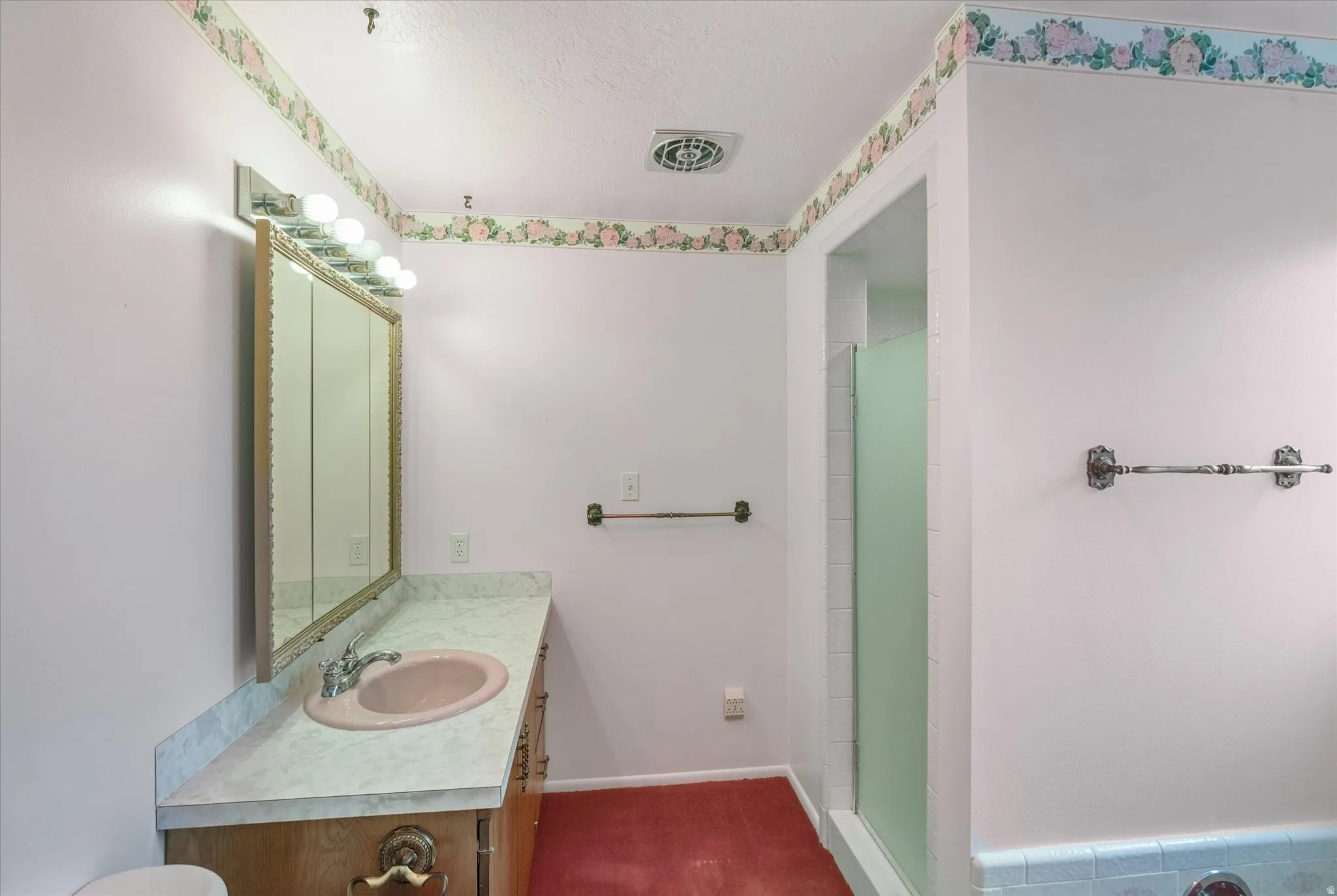 Bathroom vanity with a built-in sink and a three-panel mirrored medicine cabinet