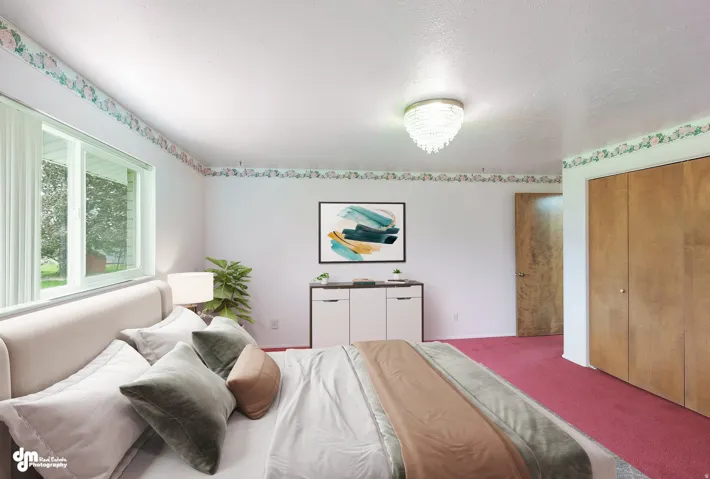Large window, wood-finish closet doors, recessed lighting, and wall-to-wall carpeting