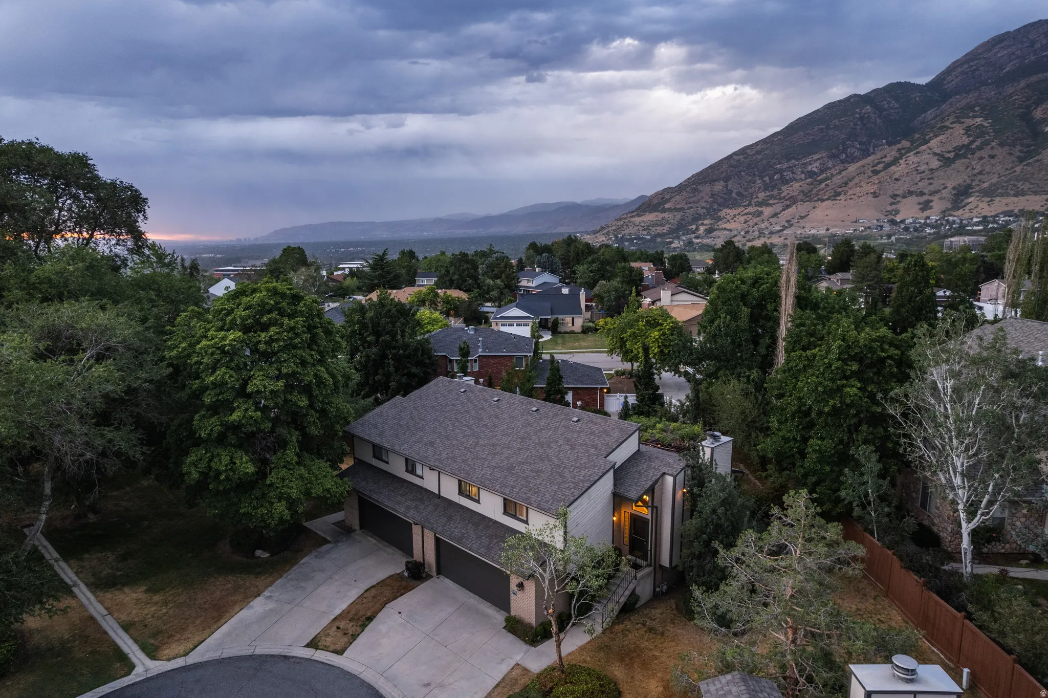 Contemporary property featuring a gray shingle roof and a multi-car garage with individual doors