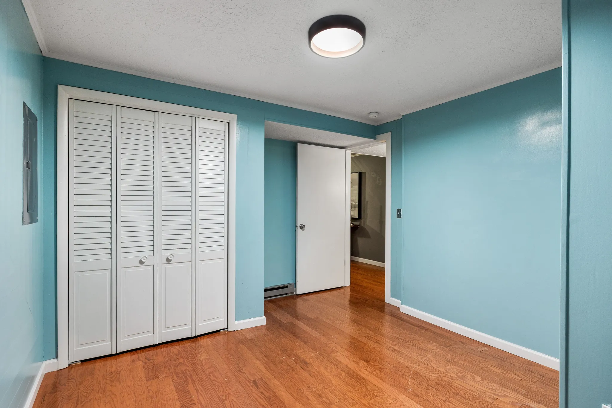 Hardwood-finish flooring complementing light blue walls