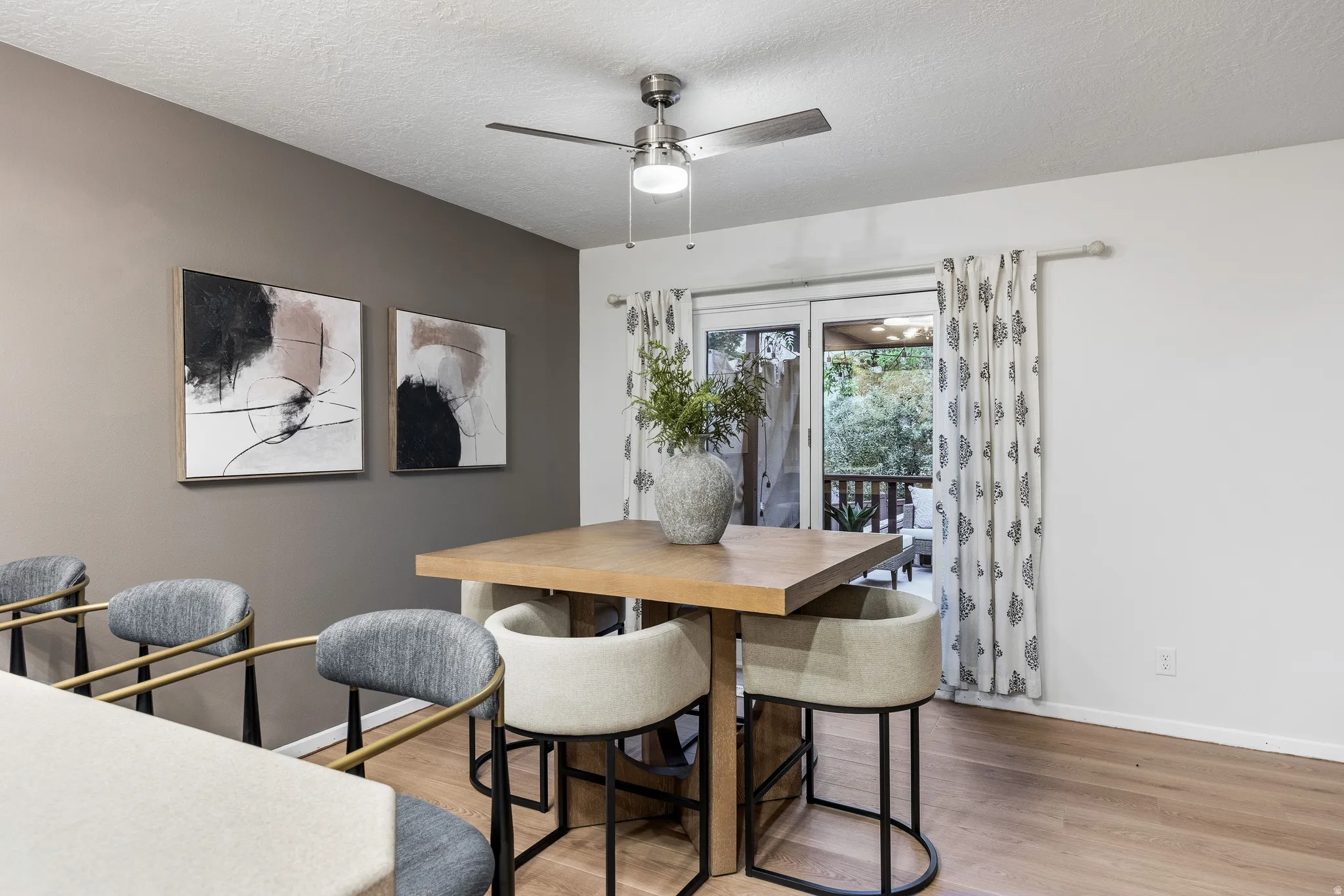 Dining area featuring wood-finish flooring and a contemporary ceiling fan
