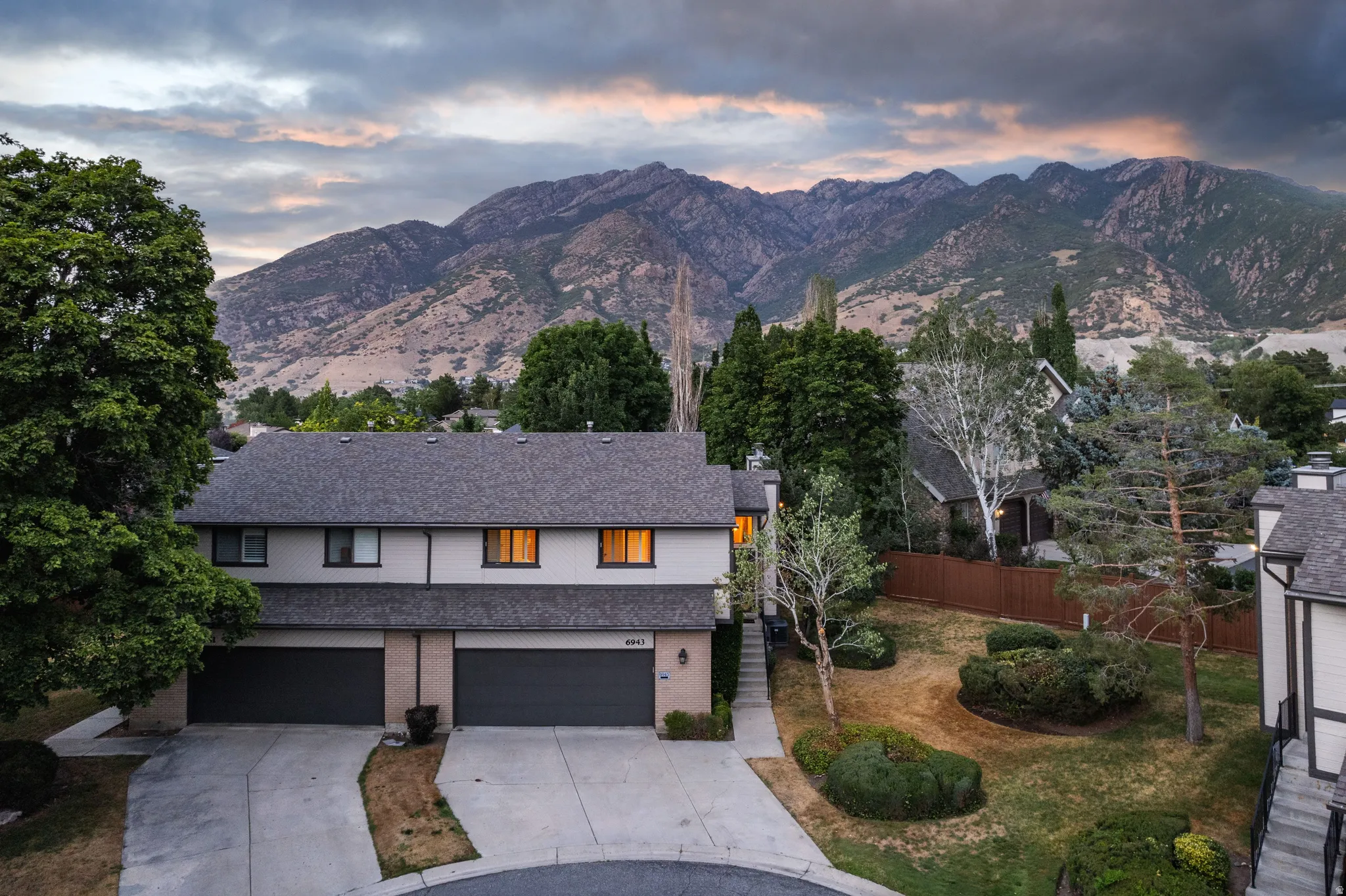 Two-story residence featuring a gray shingle roof and light-colored siding