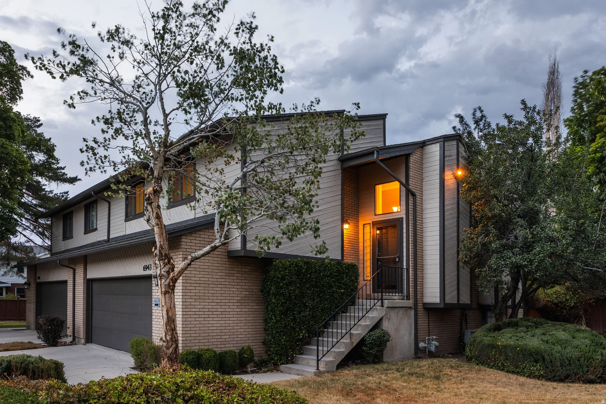 Two-story residence featuring a brick and siding exterior with a multi-level design