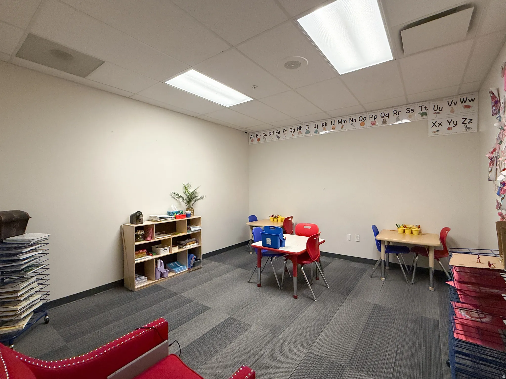 Open concept room featuring recessed lighting and modular carpet tiles