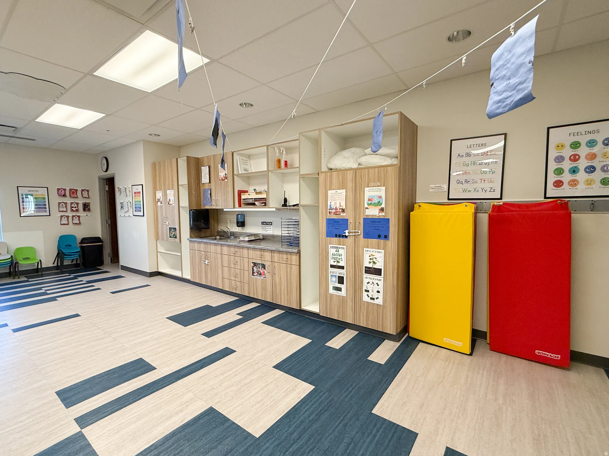 Spacious interior featuring wood-finish cabinetry with open shelving and a stone-finish countertop