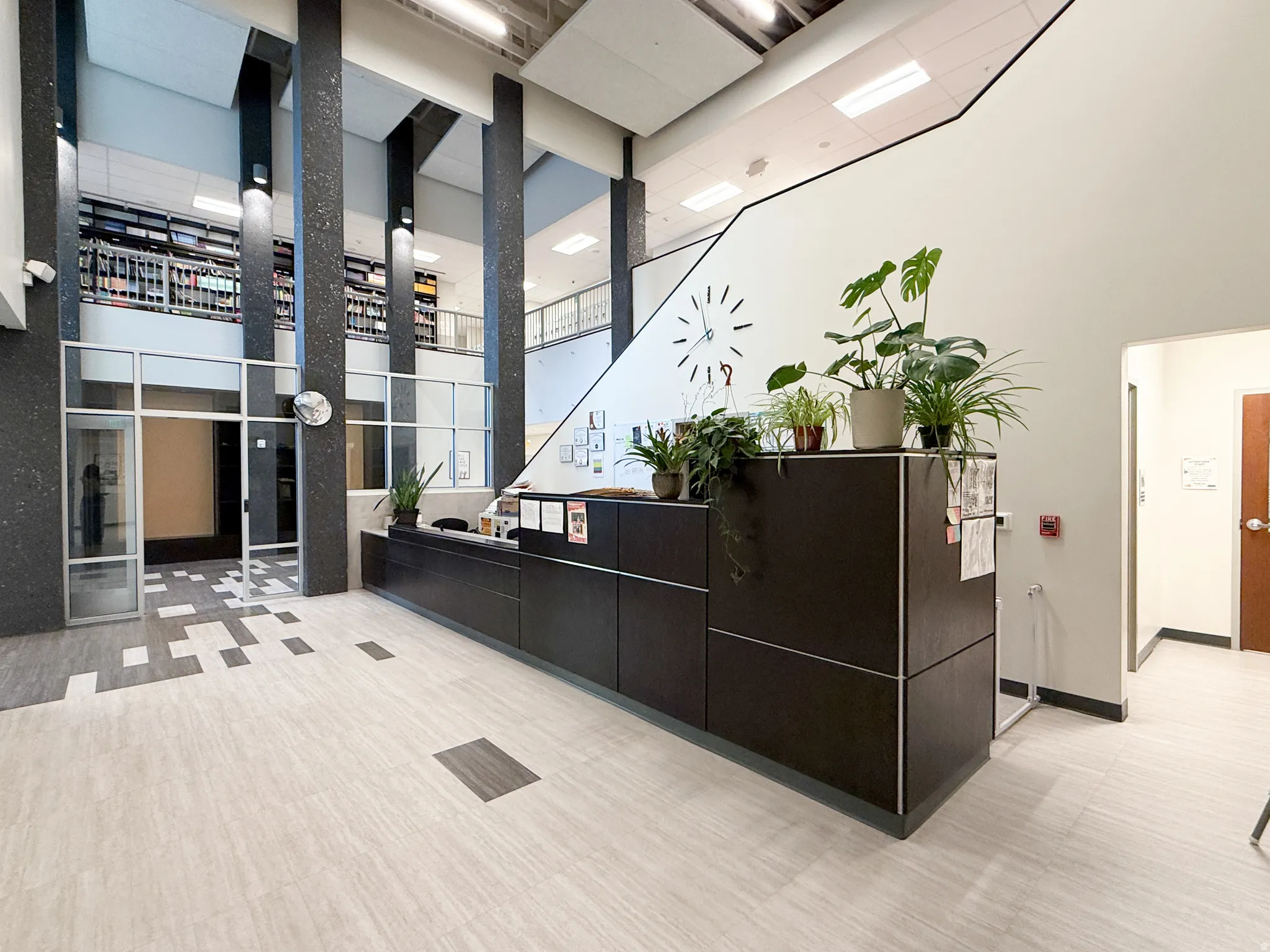Spacious reception area featuring a dark wood-finish counter with integrated storage