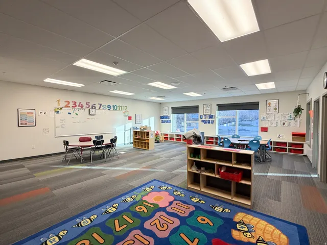 Spacious room featuring multiple large windows, recessed lighting, and patterned carpet flooring