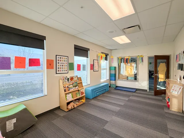 Room featuring multiple windows with roller shades, recessed lighting, and acoustic tile ceiling