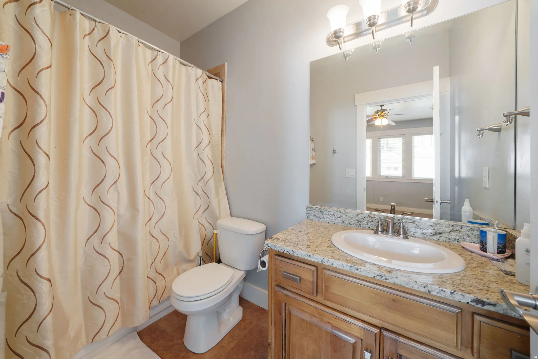 Bathroom featuring a vanity with a light-colored countertop, an oval undermount sink, and a brushed nickel faucet
