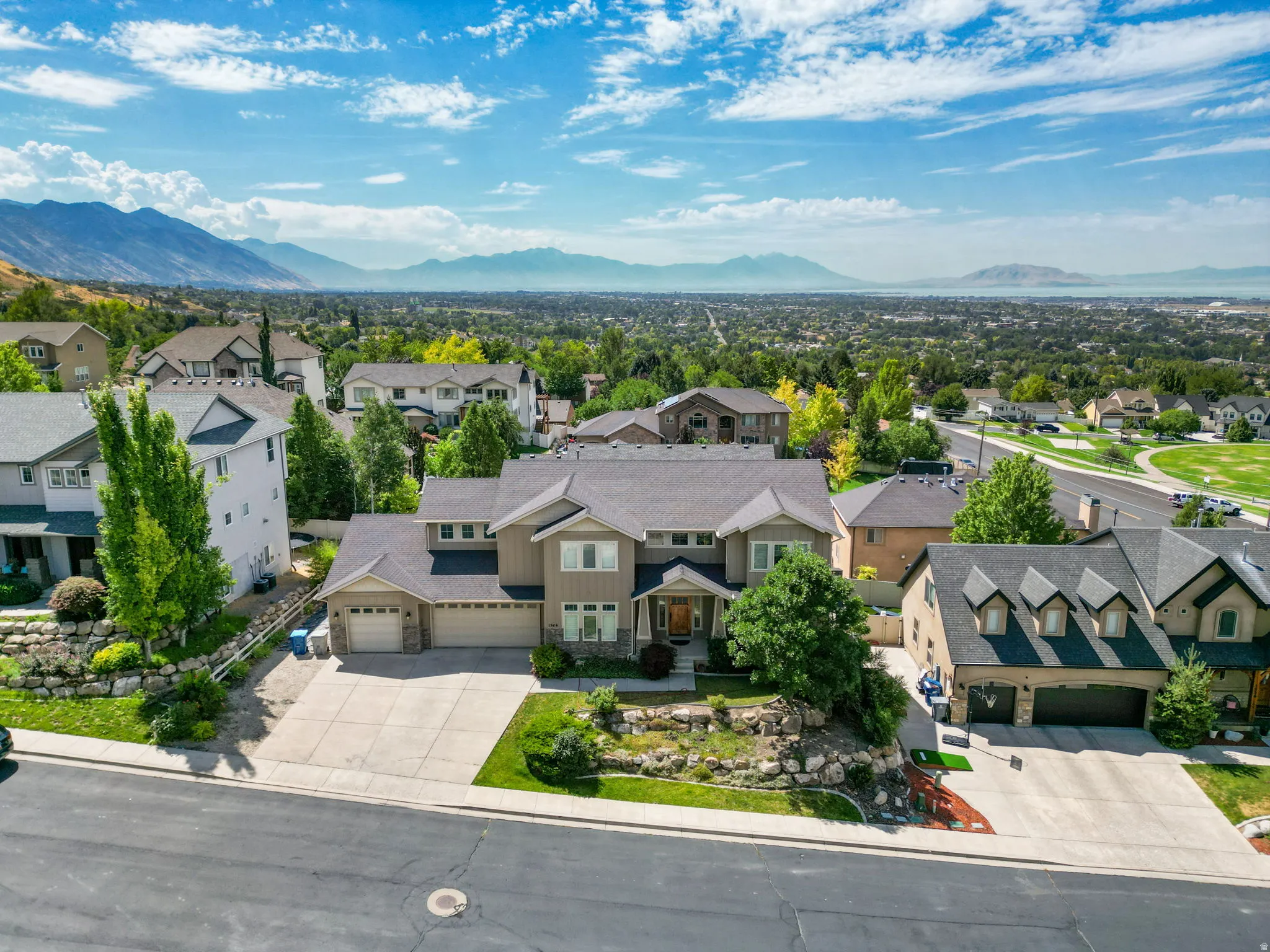 Two-story residence featuring a multi-gable roofline and a three-car garage