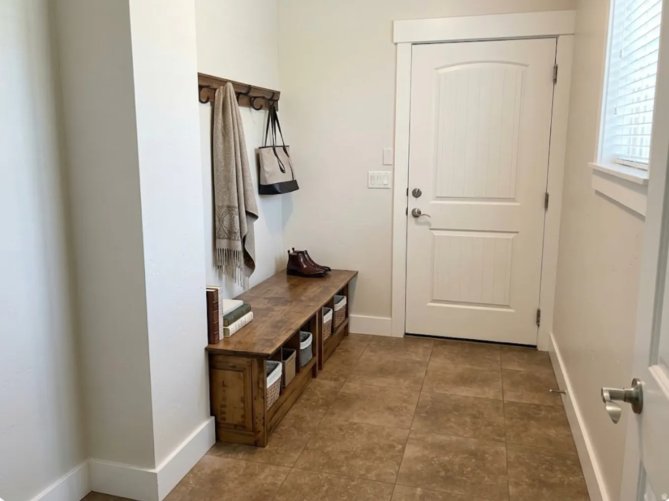 Built-in wood-finish bench with integrated storage and wall-mounted coat rack