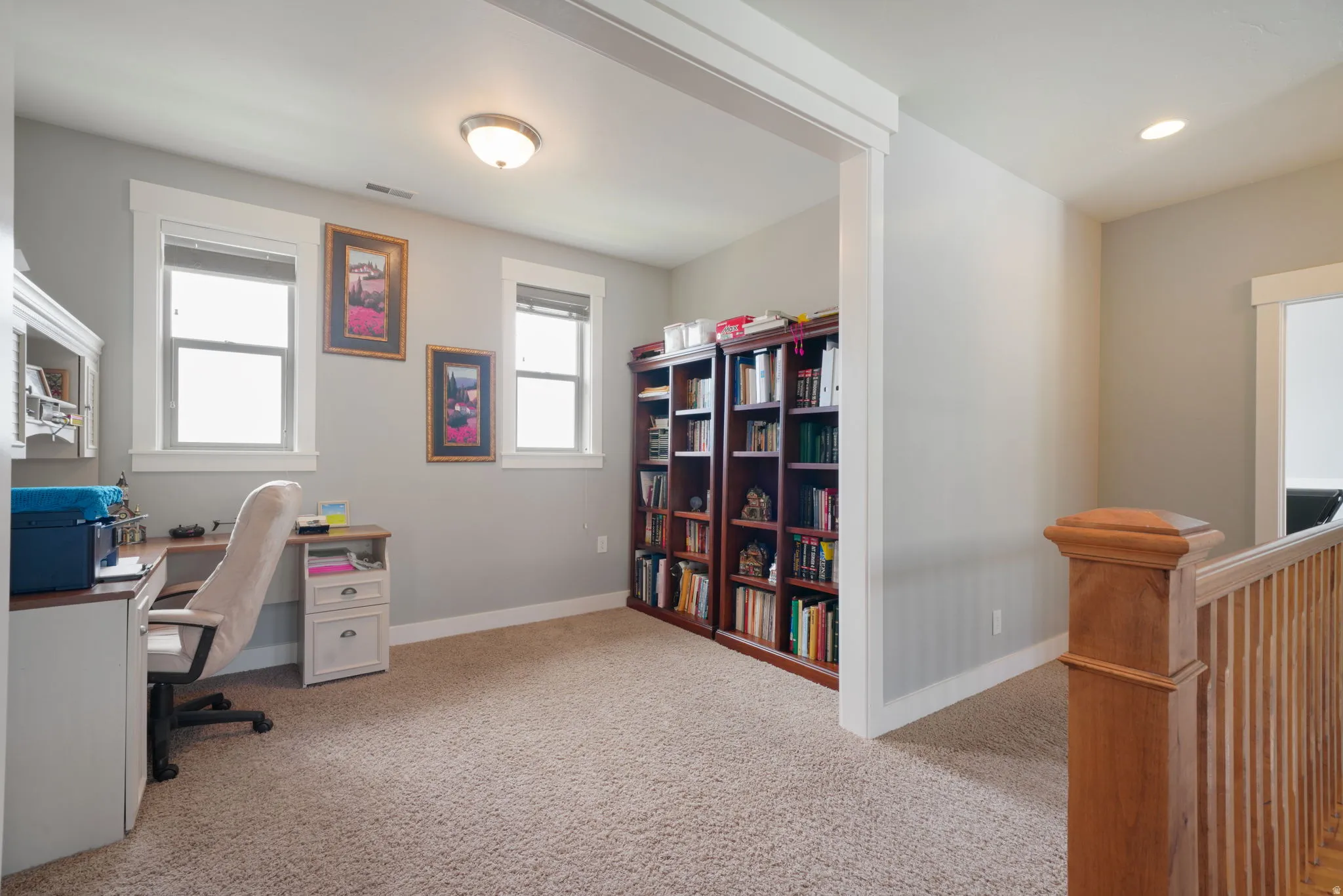 Carpeted bonus room featuring two windows with blinds, a built-in ceiling light, and recessed lighting