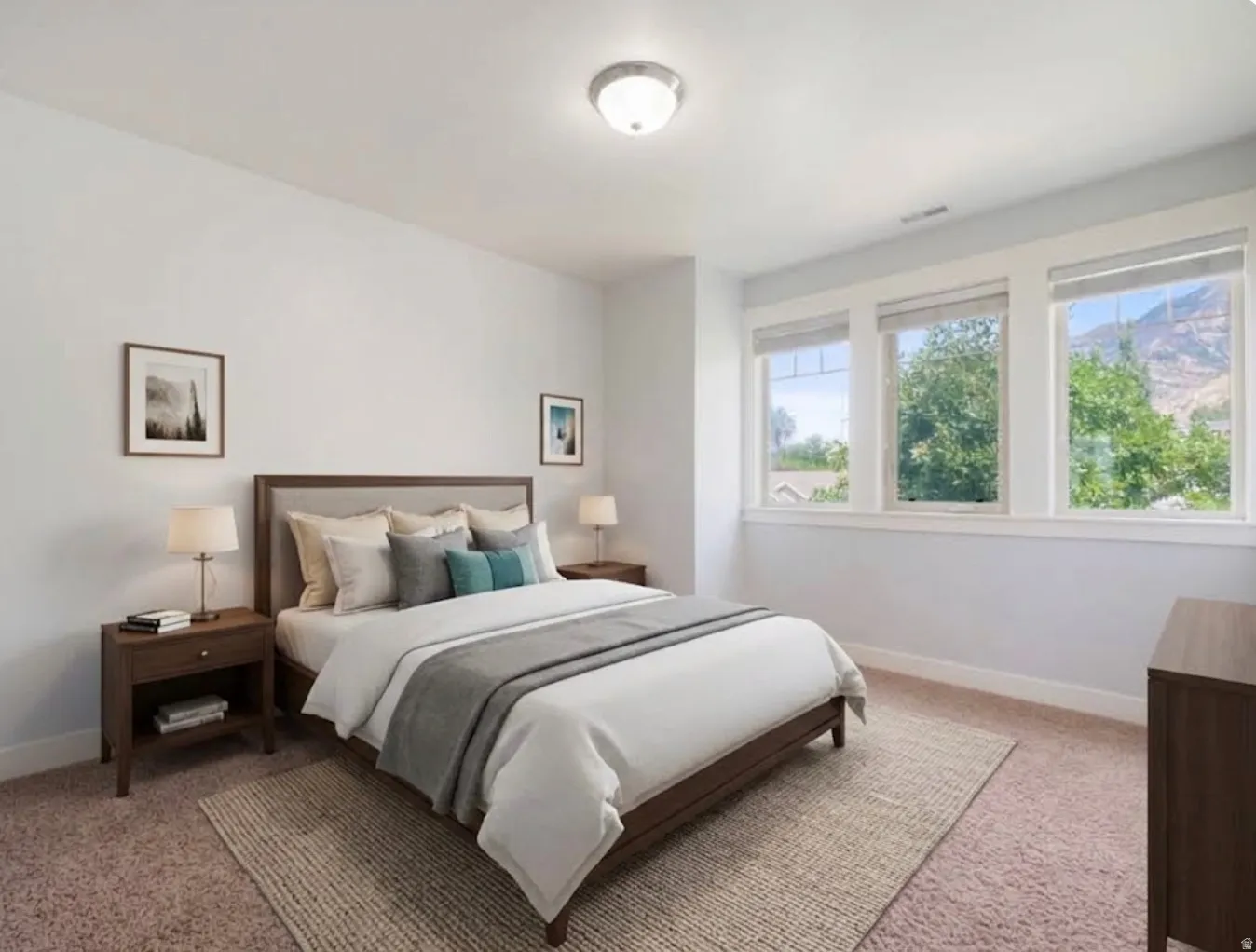 Light-filled room featuring three large windows, a neutral color palette, and carpet flooring