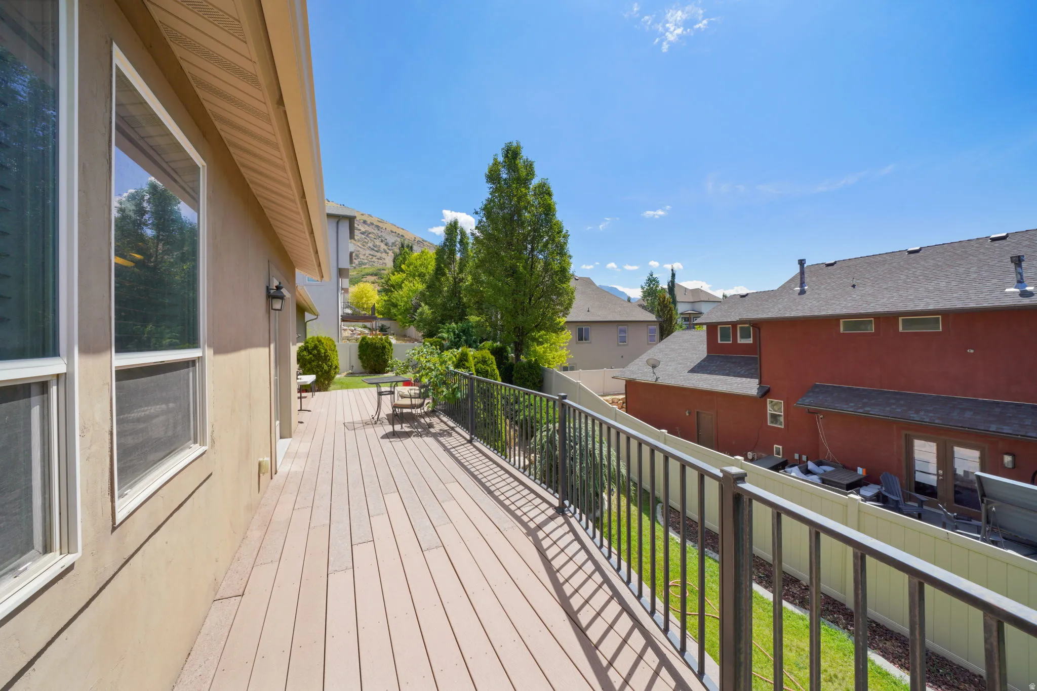 Expansive elevated deck featuring composite decking and black metal railings