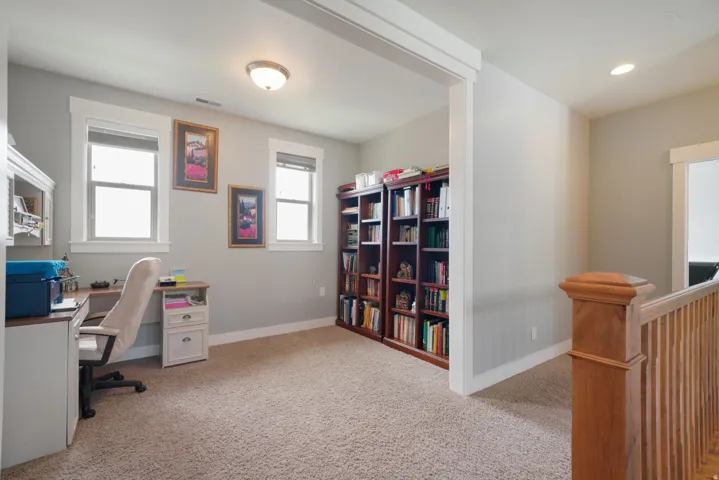 Carpeted bonus room featuring two windows with blinds, a built-in ceiling light, and recessed lighting