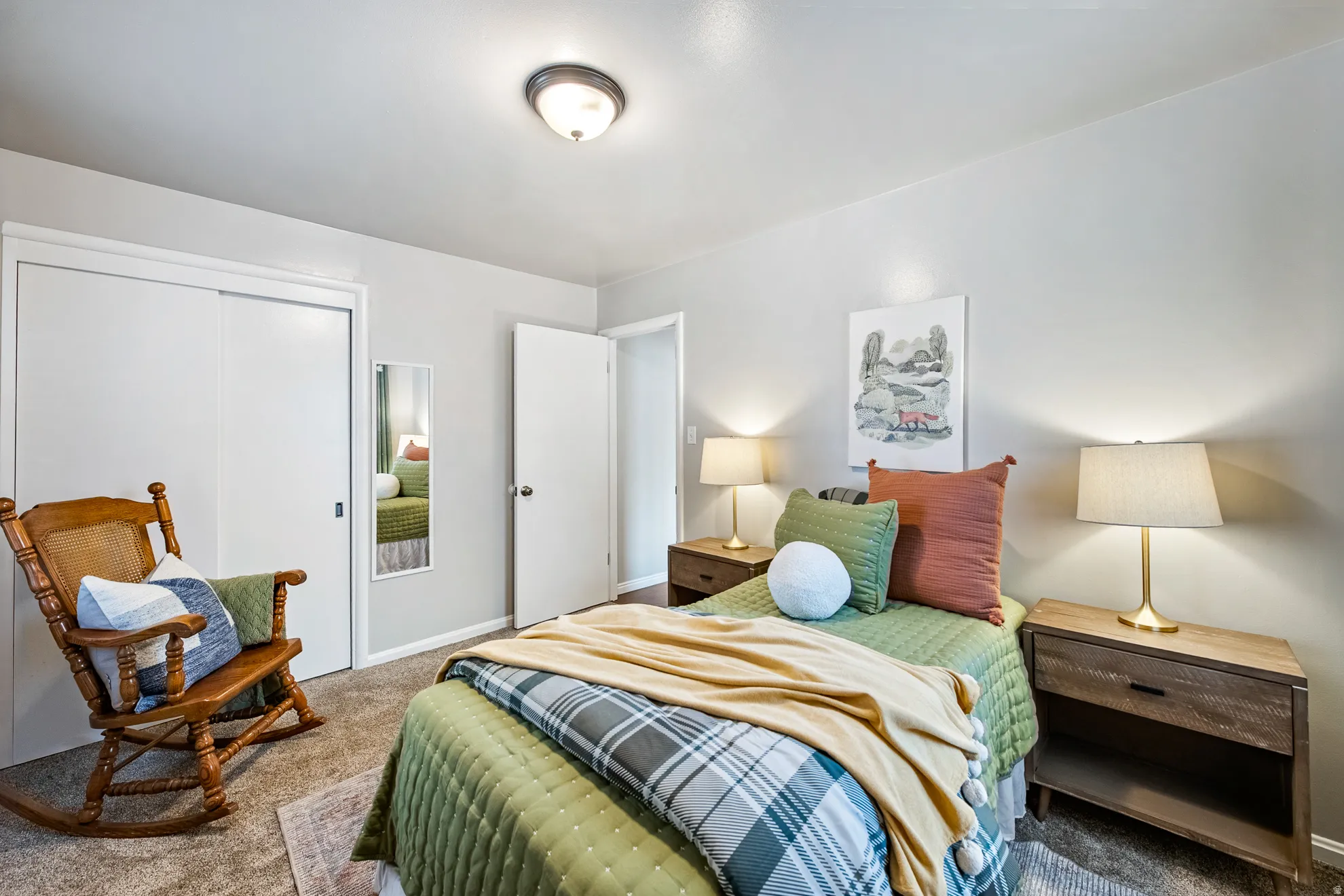 Light-toned walls, neutral carpet, and a flush-mount ceiling light