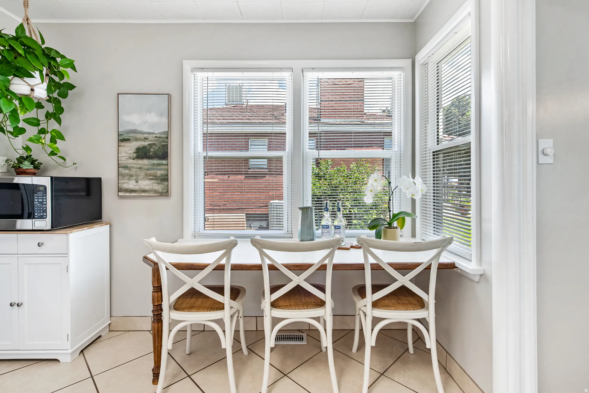 Corner window seating area with multiple windows, white window trim, and light gray walls