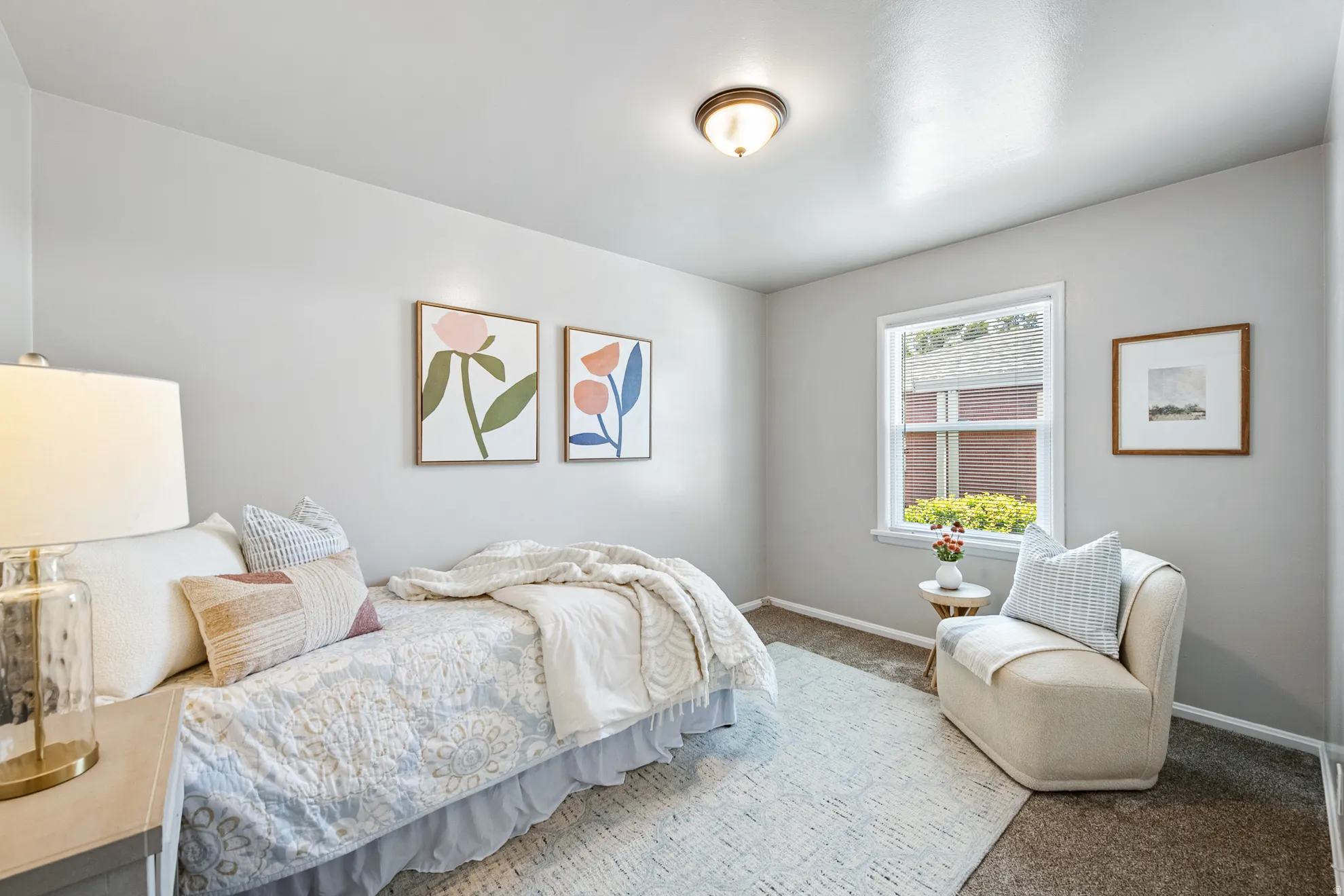 Neutral wall finishes with a single window, overhead flush mount light fixture, and carpeted flooring