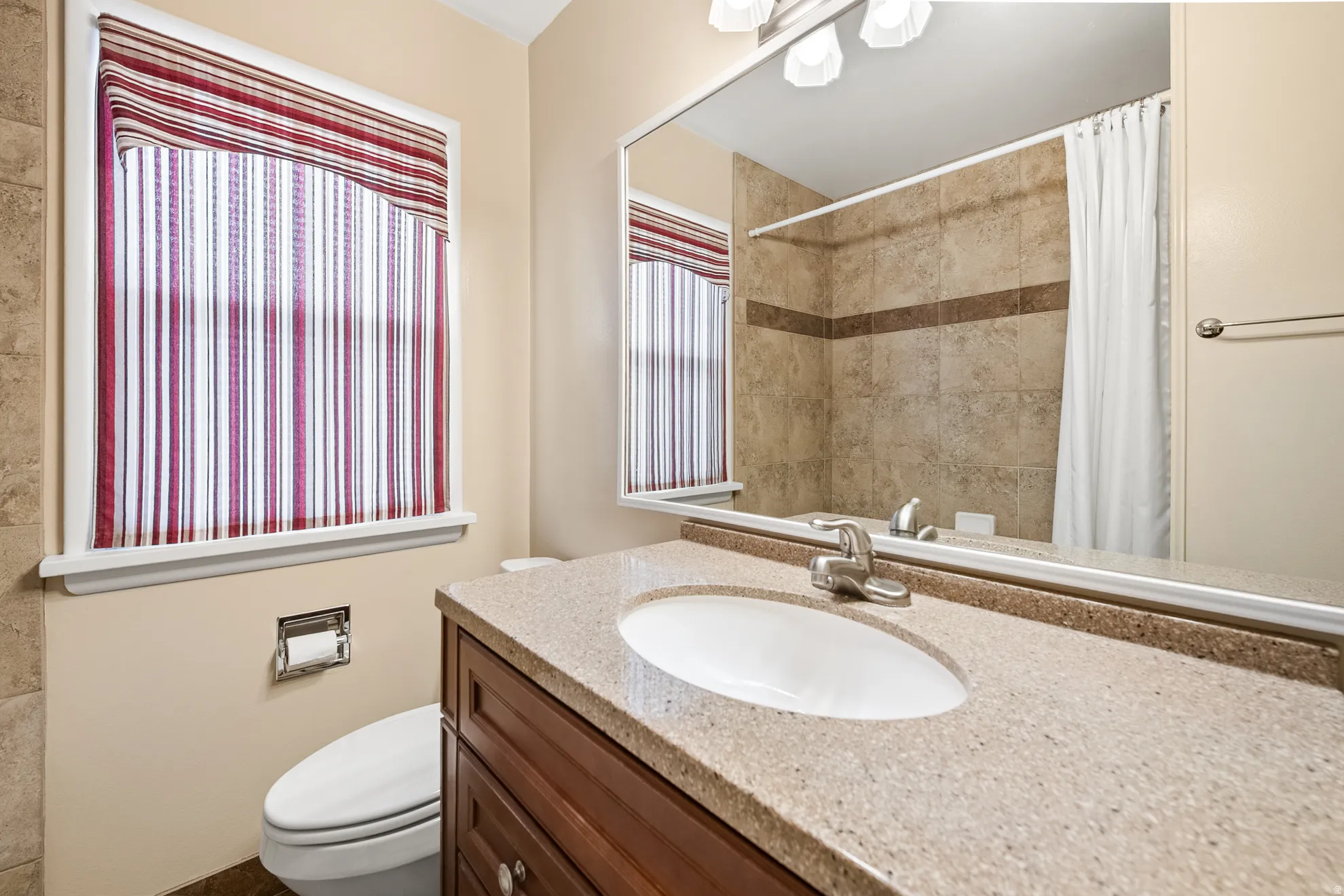 Vanity with an integrated sink and light-toned countertop