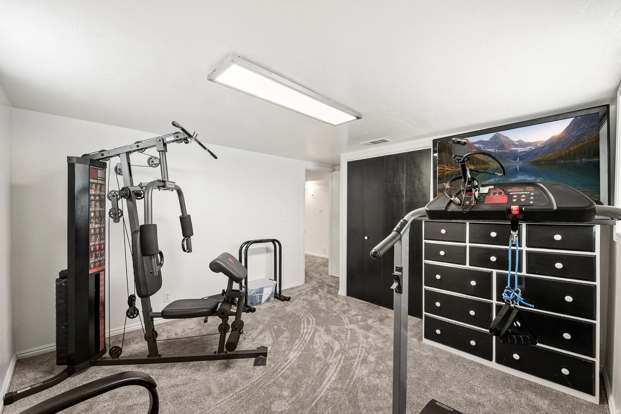 Dedicated room with grey patterned carpet and white walls