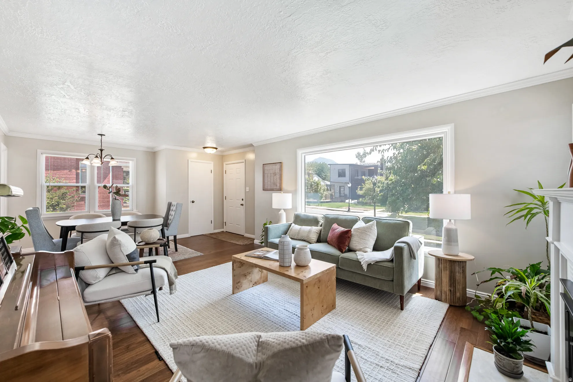 Hardwood flooring throughout, large picture window, crown molding, and recessed lighting