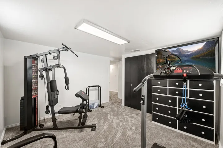Dedicated room with grey patterned carpet and white walls