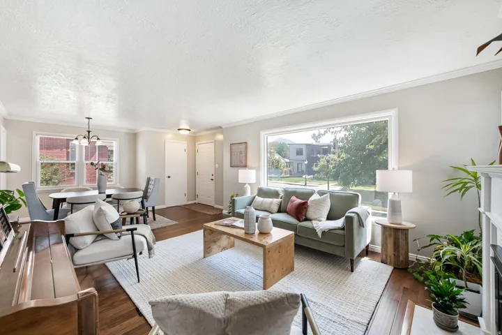 Hardwood flooring throughout, large picture window, crown molding, and recessed lighting