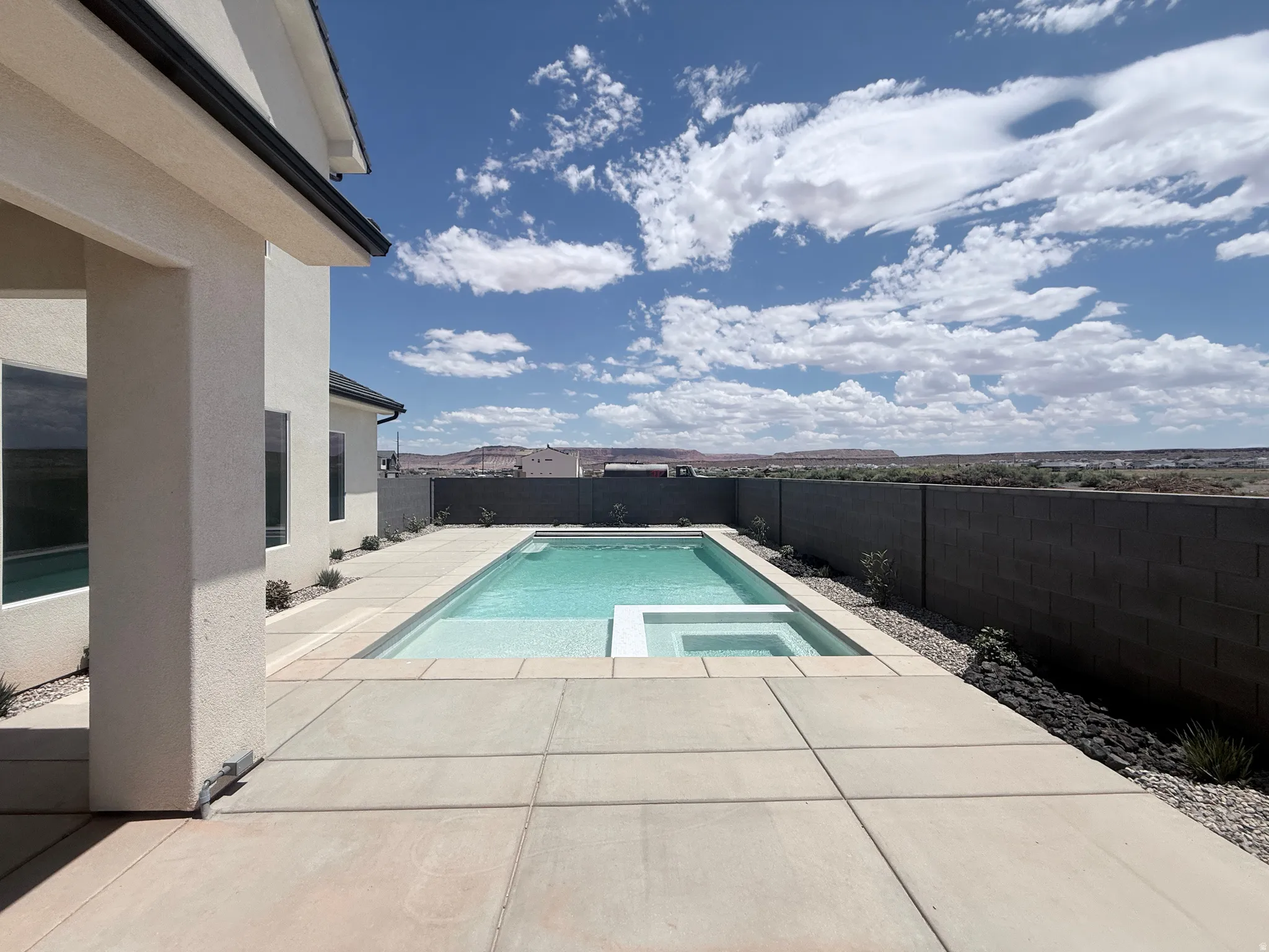 Private backyard featuring a rectangular swimming pool with an integrated spa
