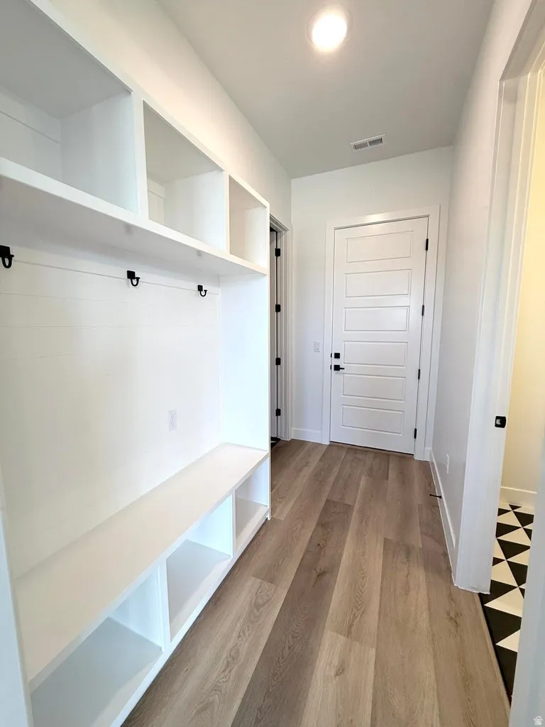 Entryway featuring built-in storage with a bench and cubbies