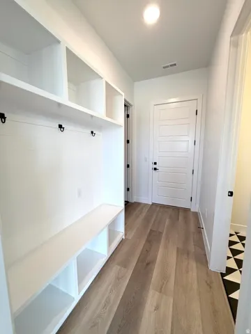 Entryway featuring built-in storage with a bench and cubbies