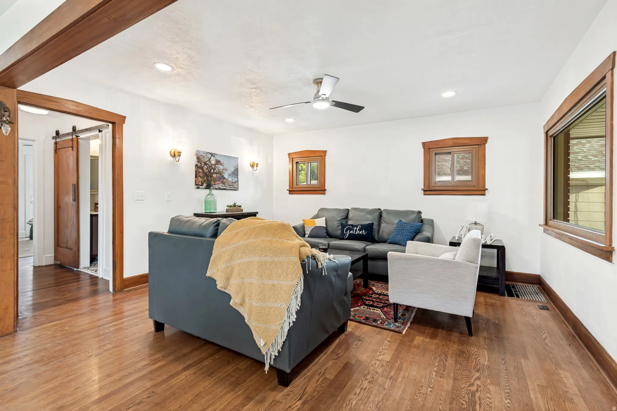 Living area featuring wood-finish flooring, recessed lighting, and a ceiling fan