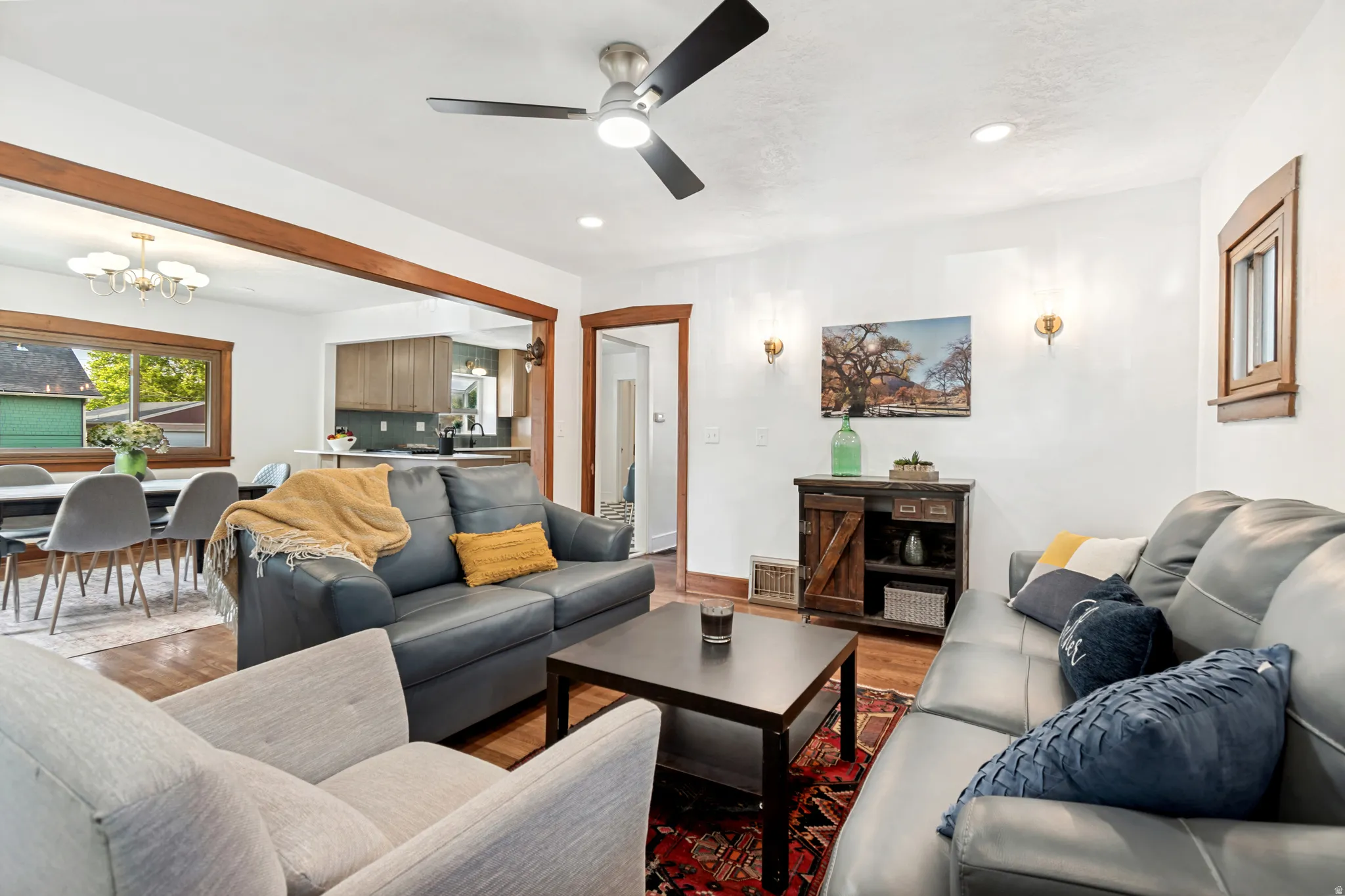Living area featuring wood-finish flooring, recessed lighting, and a ceiling fan