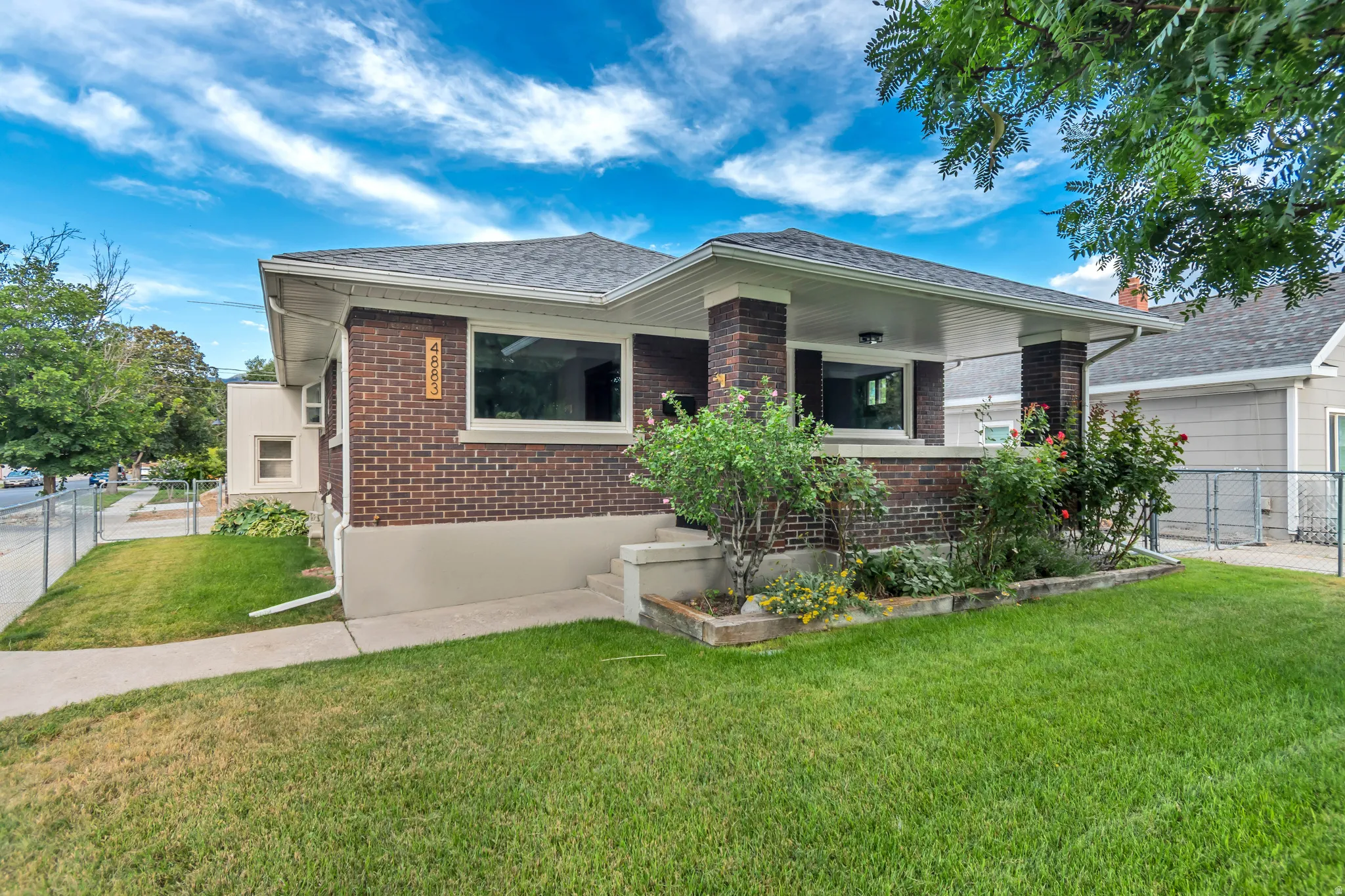 Brick and stucco exterior with a covered front porch featuring square columns