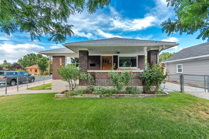 Brick exterior with a covered front porch featuring white soffits and dark trim