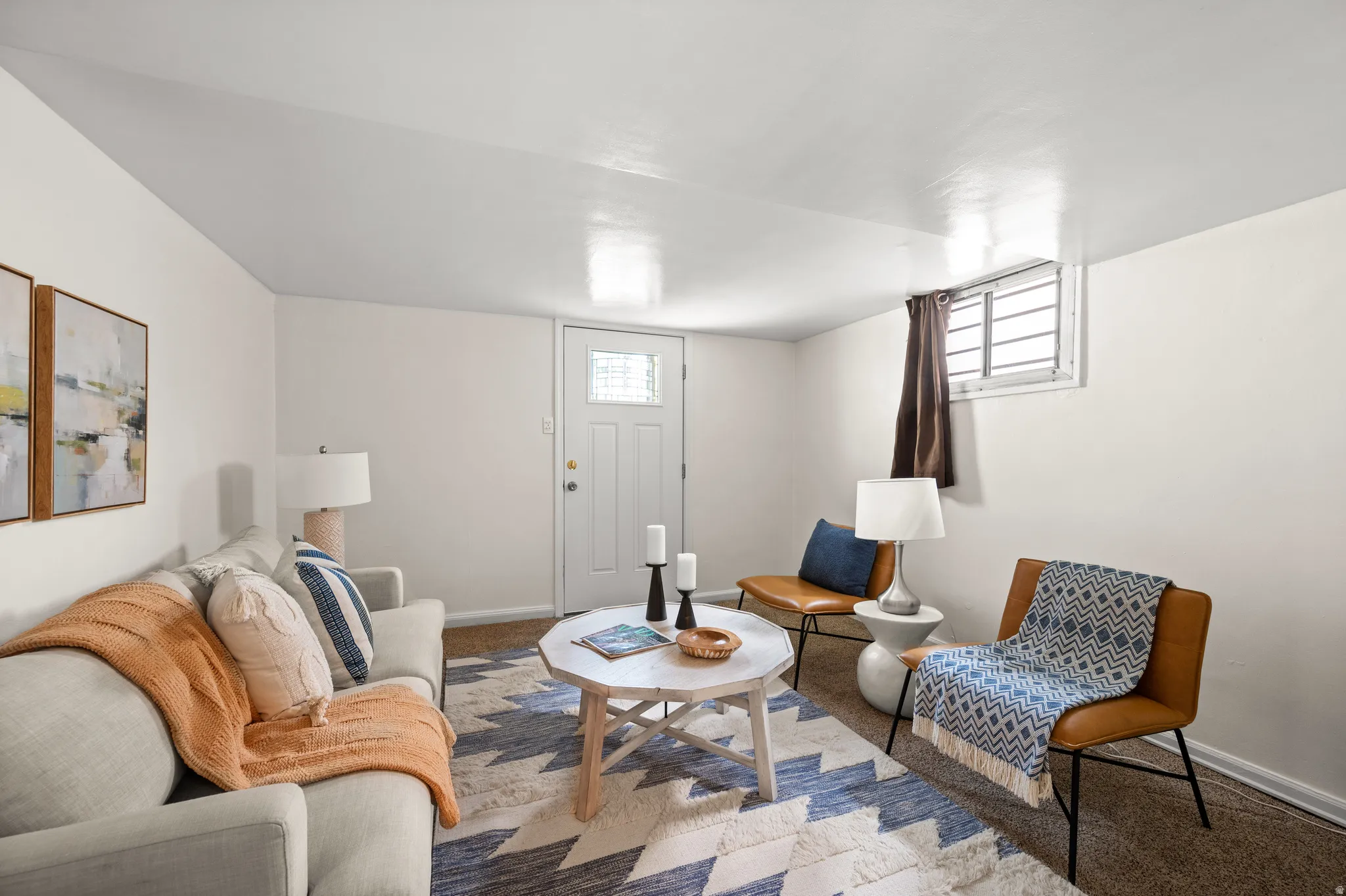 Finished living space featuring soft neutral walls and carpeted flooring