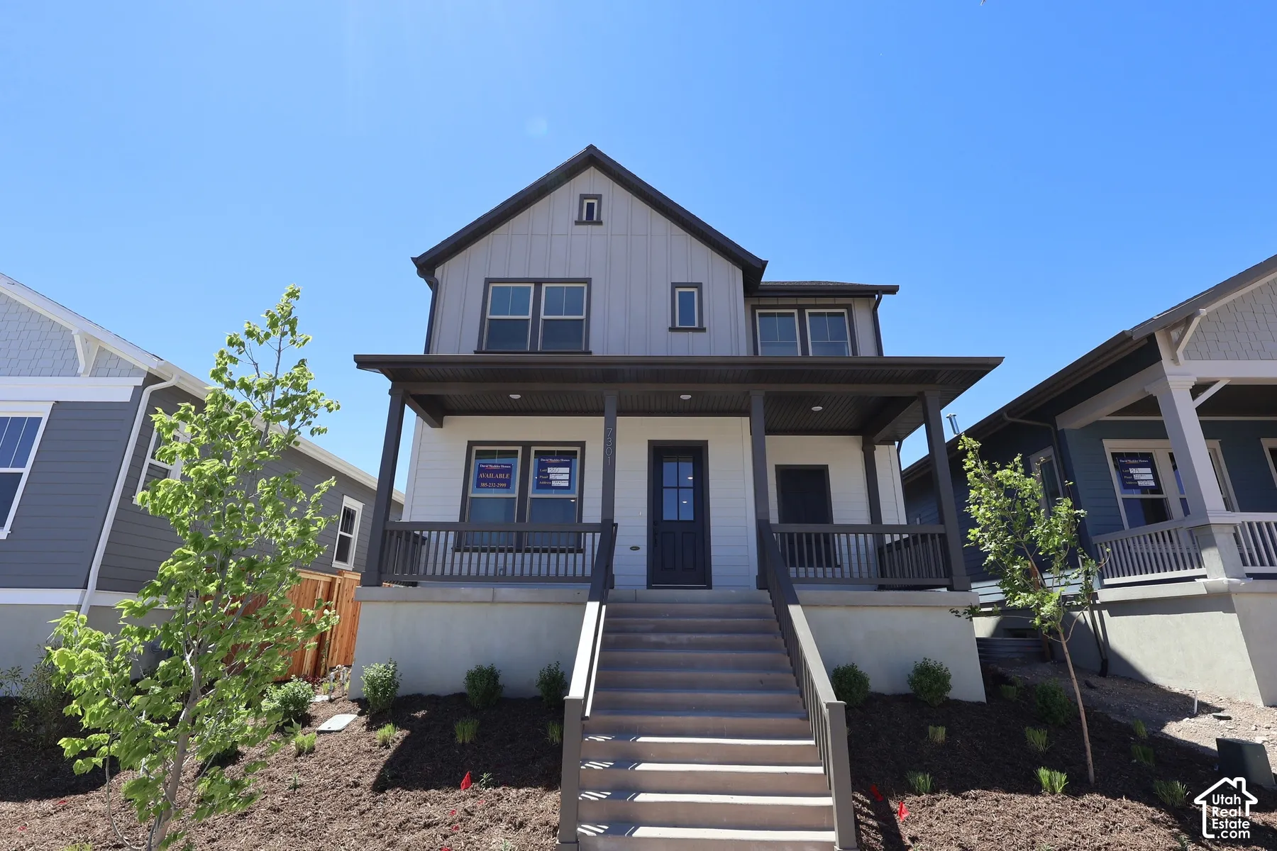 Modern farmhouse exterior featuring board and batten siding and a covered front porch