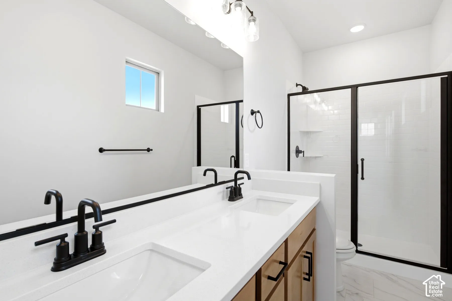 Dual vanity with undermount sinks and matte black fixtures