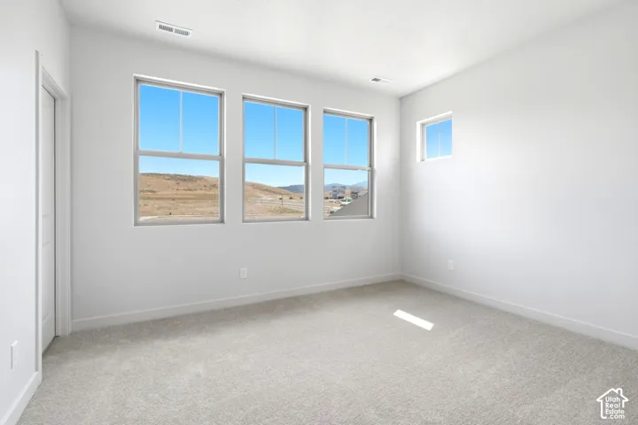 Light grey carpet flooring complements crisp white walls