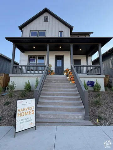 Modern farmhouse-inspired exterior with light-colored siding and dark trim