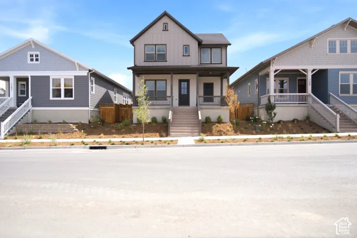 Contemporary two-story home featuring a dark gray and white exterior with board and batten siding accents
