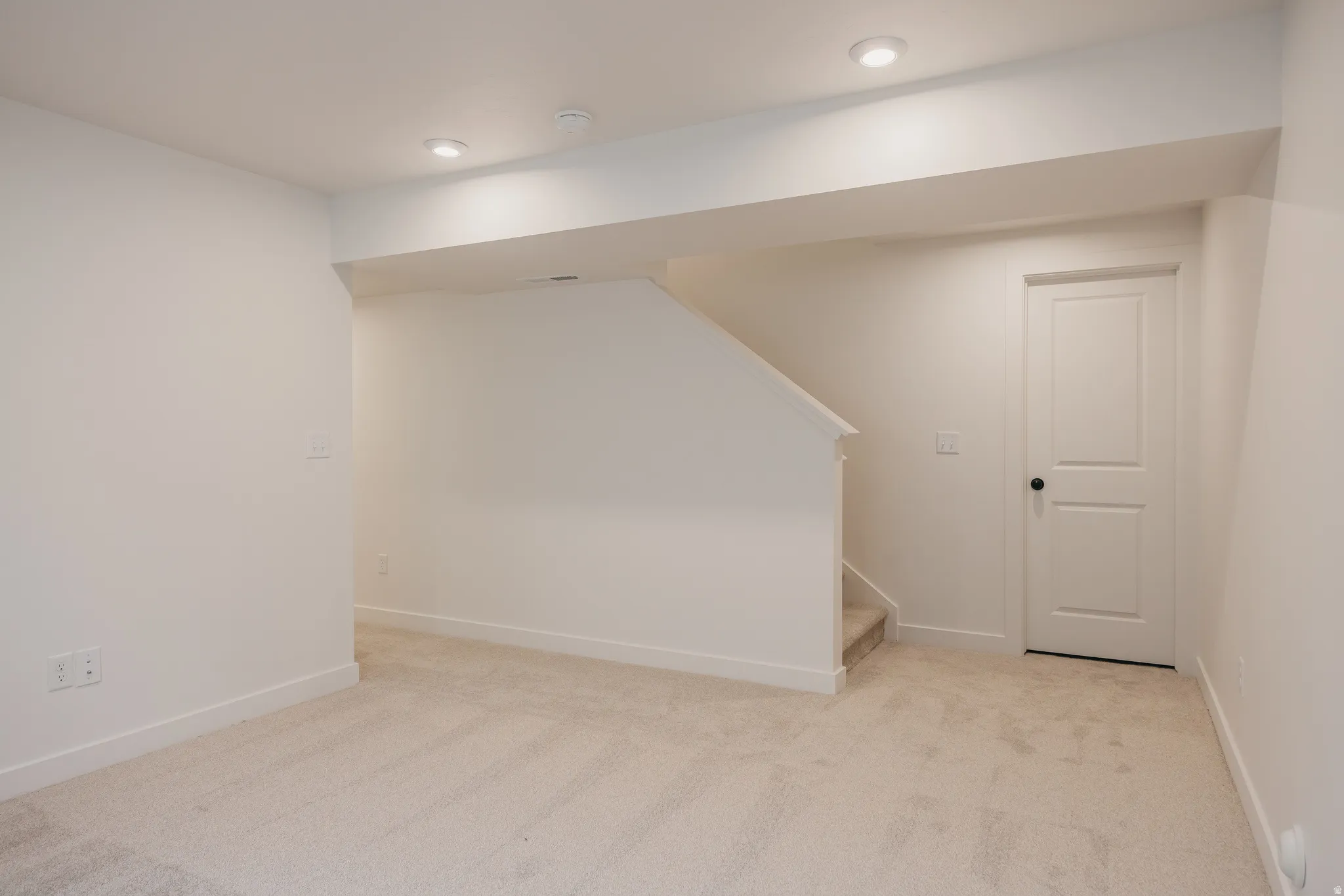 Neutral-toned wall-to-wall carpeting throughout