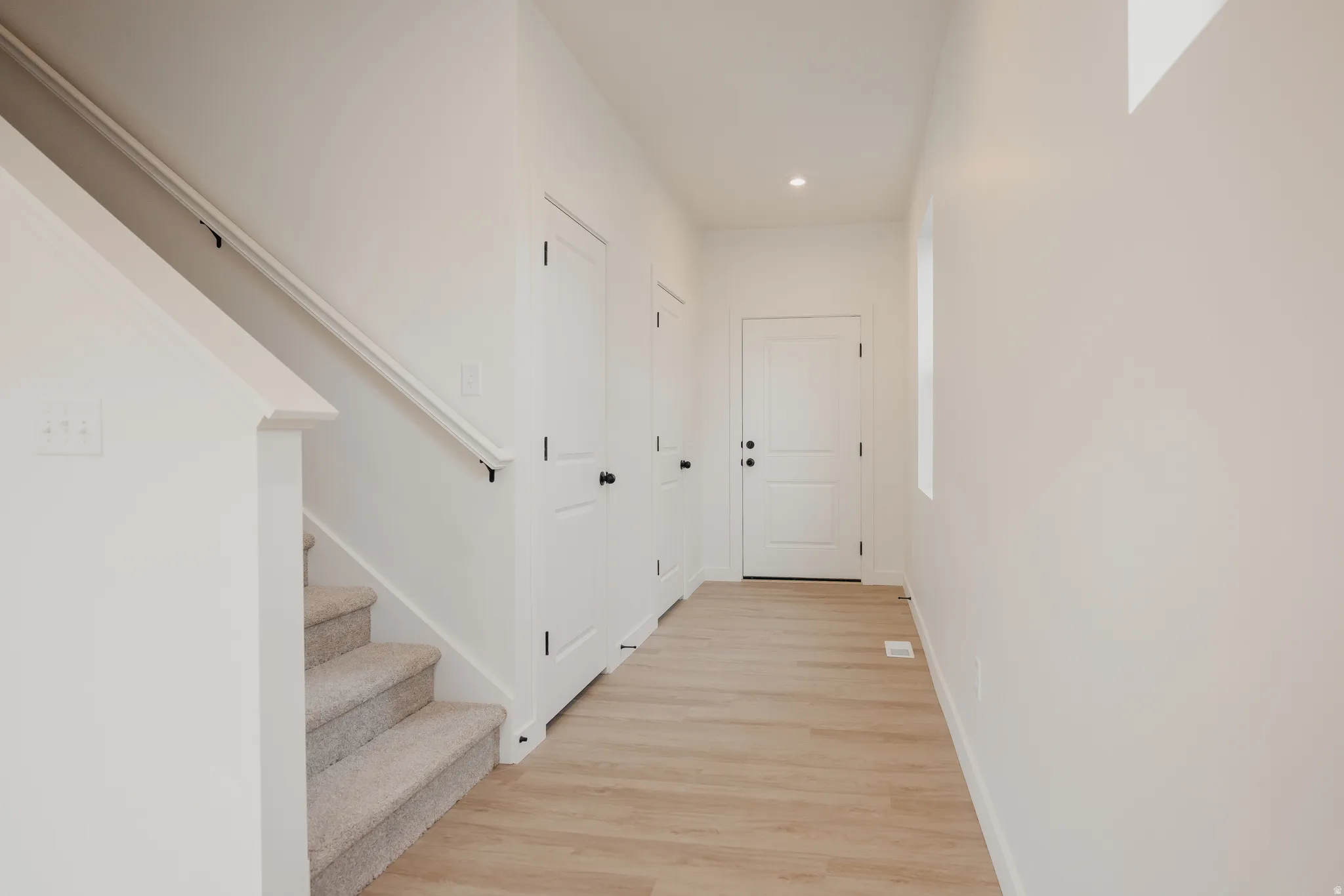 Entryway featuring light wood-finish flooring and a neutral color palette